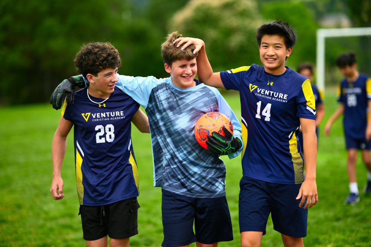 Venture Christian Academy middle school soccer players laughing together on the field